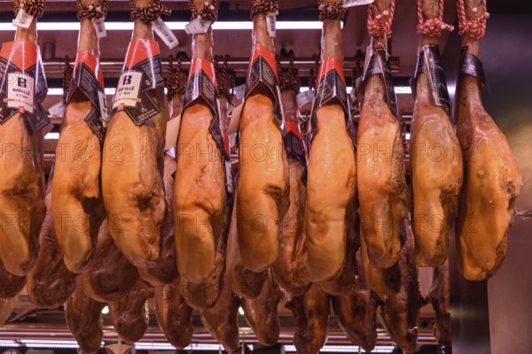 The stalls selling Jamón Serrano, the dry-cured Spanish ham made with Iberian pigs, in Barcelona, Spain
