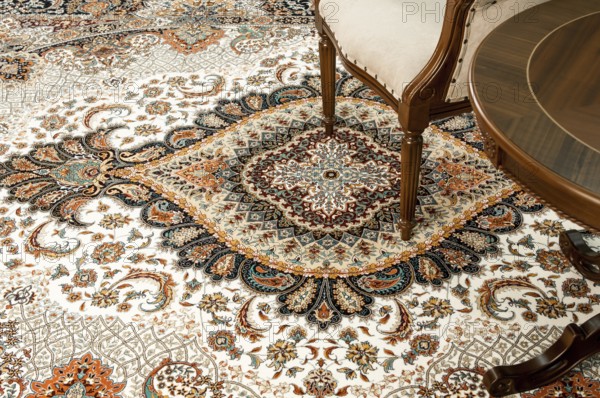 Antique chair and table on the decorated oriental carpet