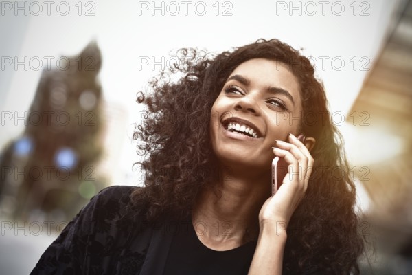 Happy beautiful woman walking and writing or reading sms messages