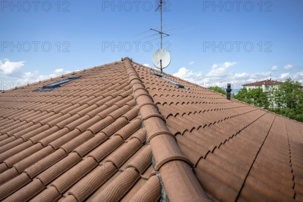 Red roof of the building against the blue sky. Copyspace for text, promotion or advertisement