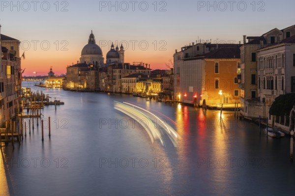 Morning atmosphere in front of sunrise, view of the Grand Canal from the Ponte dell' Accademia, Basilica Maria della Salute in the background, long exposure, Venice, Italy