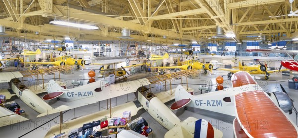 Calgary, Alberta, Canada. Aug 5, 2024. Several vintage aircraft on display in a the Hangar flight museum. The aircraft are of various sizes and colors, and some are suspended from the ceiling