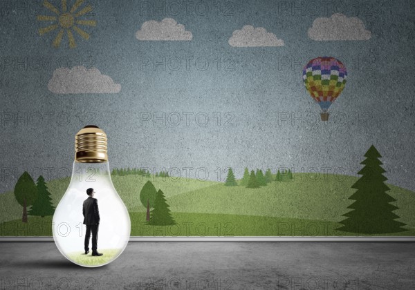 Businessman inside light bulb in room against nature drawn concept