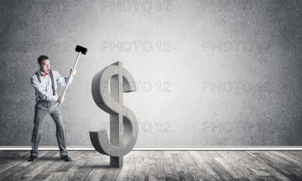 Young furious businessman going to crash with hammer stone dollar symbol