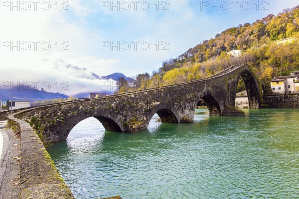 Bridge of Mary Magdalene in Borgo a Mozzano. Italy, province of Tuscany. Impressive medieval bridge over the Serchio River. The green cold water reflects the ancient arches of the bridge