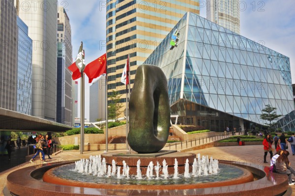 HONG KONG, DECEMBER 11, 2014: Hong Kong Special Administrative Region. Square in downtown decorated with fountain and abstract sculpture. The modern city on the ocean coast