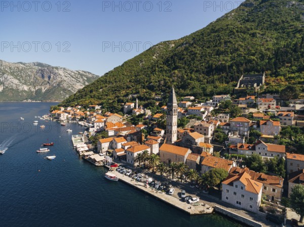 Drone view of the Perast coast with ancient houses and a tower. Montenegro.