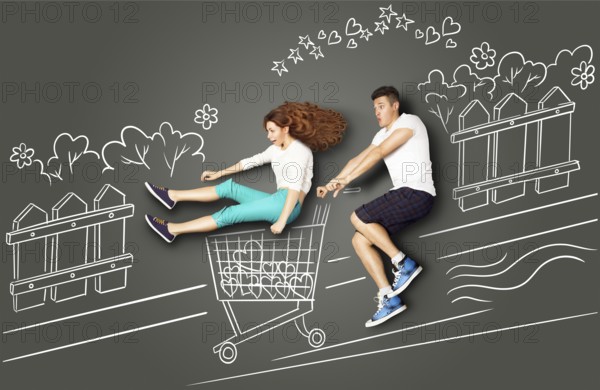 Happy Valentine's Day love story concept of a romantic couple on chalk drawings background. Male riding his girlfriend in a shopping trolley along the street