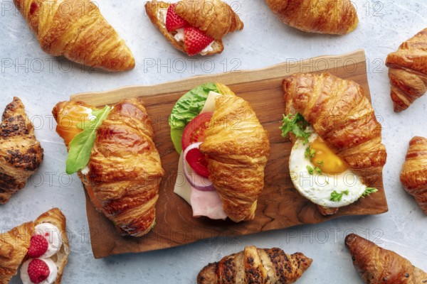 Croissant sandwich variety. Various stuffed croissants, overhead flat lay shot. Many rolls filled with ham, salmon, egg, etc, Food photography, Food photography
