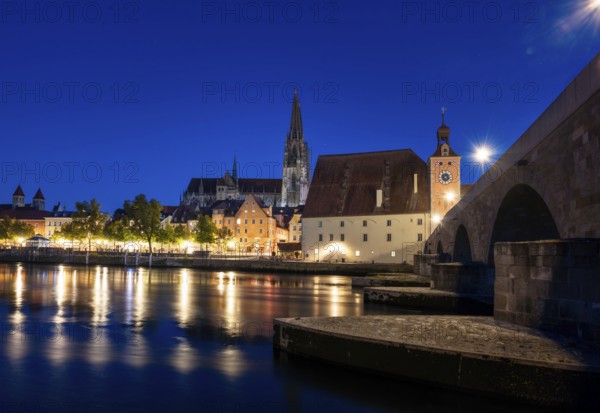 Regensburg cityscape during blue hour with light reflections in the river Danube