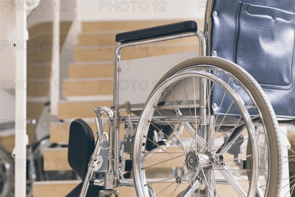 Empty wheelchair and stairs. Disabled accessibility reality