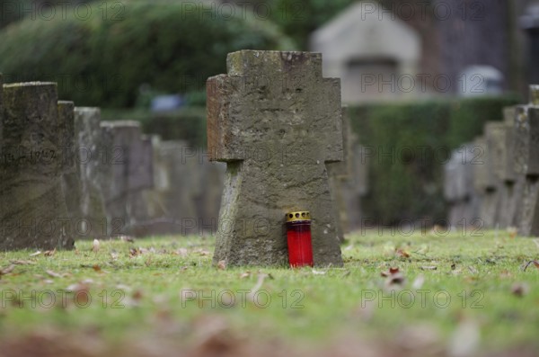 Gravestones and grave light at a military cemetery from the Second World War in Germany