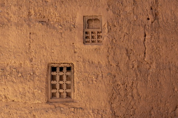 Two little windows in a typical berber house built of clay, Draa valley in Morocco