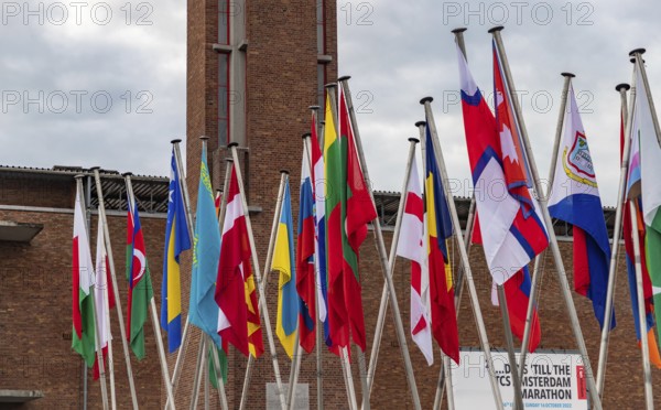 A picture of many country flags in front of the Olympic Stadium as part of the 2022 edition of the Amsterdam Marathon