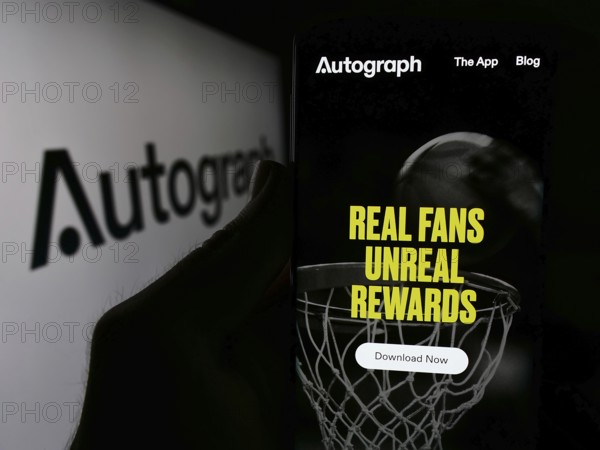 Stuttgart, Germany, 06-01-2024: Person holding smartphone with website of US NFT company LFG NFTs Corp. (Autograph.io) in front of logo. Focus on center of phone display