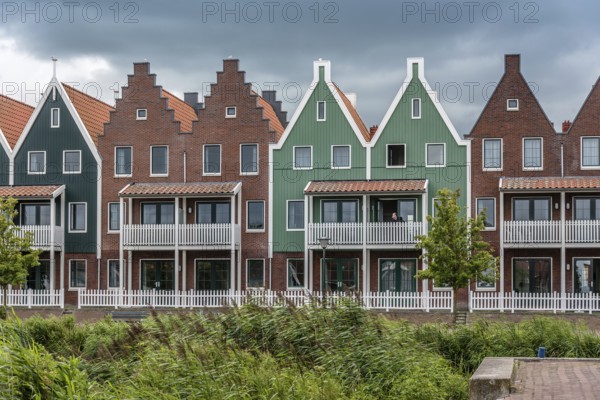 Veolendam, Netherlands, August 08, 2016. Houses in the marina of Volendam. Volendam is a popular tourist attraction in the Netherlands, well known for its old fishing boats and the traditional clothing still worn by some residents