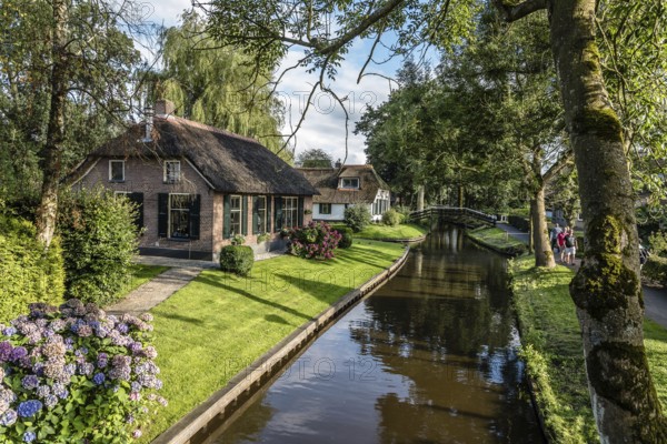 Giethoorn, Netherlands, August 5, 2016: The village Giethoorn is unique in the Netherlands because of its bridges, waterways and typical boats calle punters. It is also called the Venice of Holland