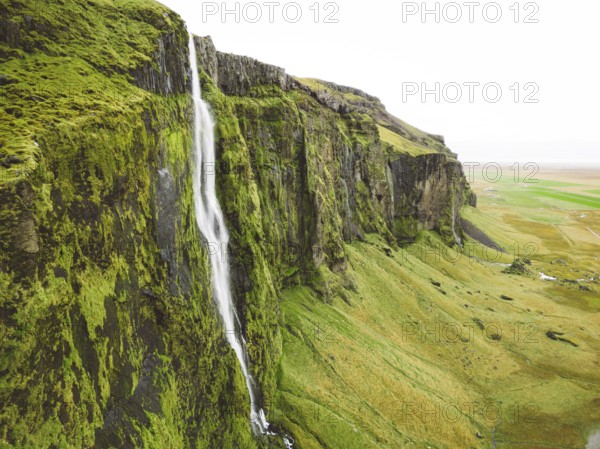 Iceland waterfall nature travel landscape in Icelandic nature background. Popular tourist attraction summer holiday destination in on South Iceland.