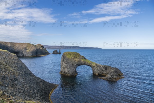 Rocky coast with Gatastakkur rock gate, Rauðanes peninsula, Norðurland eystra, Iceland
