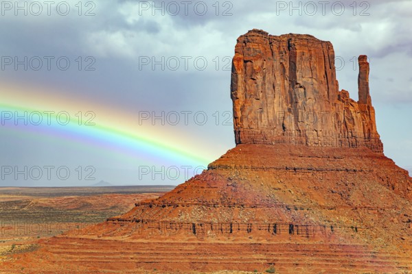 The famous rock Mittens and the bright rainbow. USA. Navajo Indian Reservations. Monument Valley is a unique geological formation in Arizona and Utah