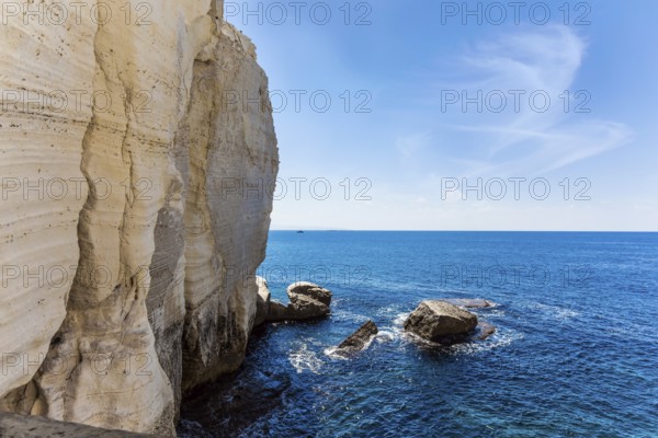 Israel. The color of sea water changes from azure to dark blue. Karst cave Rosh-a-Nikra on the shores of the Mediterranean Sea. The concept of active, environmental and photo tourism