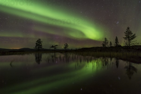 Northern Lights (Aurora borealis) reflected in a mountain lake, Gällivare, Norrbotten, Lapland, Sweden, October 2013