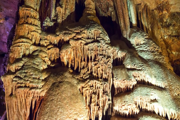 Venetsa Cave in Bulgaria. Beautiful colorful and illuminated cave full with semiprecious onyx stones. Flowstones, stalactites and stalagmites lighted in different vivid colours