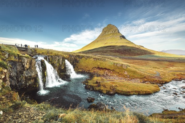 Landscape view of Kirkjufellsfoss In the daytime, blue sky and beautiful clouds. The waterfall is famous and a popular tourist spot in Iceland.
