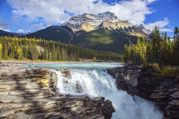 Athabasca Falls, popular with tourists. Rocky Mountains of Canada. The Athabasca River begins at the Columbia Glacier in Jasper Park. Travel, ecological and photo tourism concept