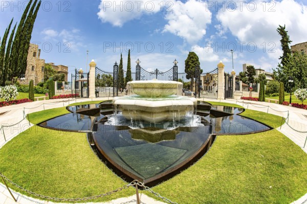 Magnificent marble fountain. Pilgrimage center and popular tourist destination. Photo taken with Fisheye lens. Bahai World Center. Mount Carmel. Haifa. Israel. Clear sunny day