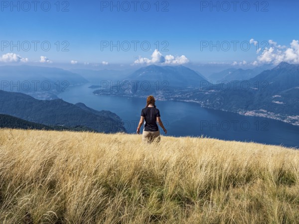 Woman walking in a prairie on Lake Como alps