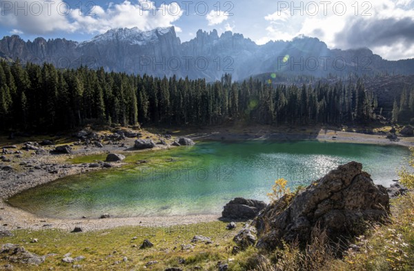 Lake Carezza or Karersee lake with deep blue colored water and the dolomite mountain range Trentino Alto Adige Region, Italy