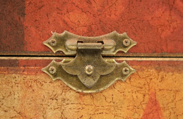An old tarnished clasp fastening a lid to a box