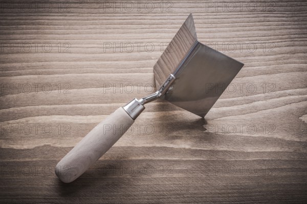 Hand angle former with wooden handle on wood board