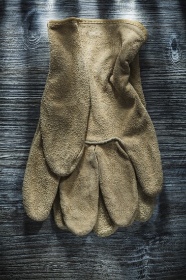 Safety gloves on wooden board