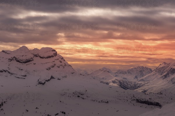 Colored sky at sunset sunset in snowy mountains. Flaine, Grand Massif, France, Arâches-la-Frasse, France