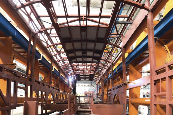 One working day of modern automatic bus trolleybus car production with unfinished cars workers in protective uniform in factory background automobile assembly line welding arm
