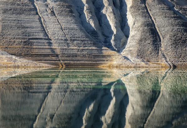 Nature abstract painting created from mountain slopes on water in a lake