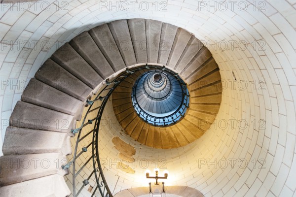 Penmarch, France, August 2, 2018: Spiral staircase in Eckmuhl Lighthouse in Brittany. Directly below view