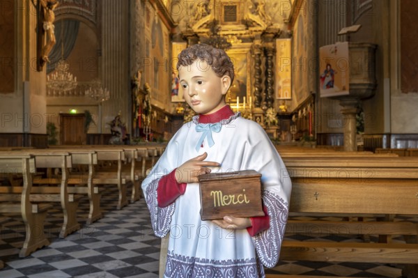 Altar boy sculpture with Merci donation box for the collection in the Catholic Cathedral Notre-Dame de l'Assomption, Ajaccio, Corsica, France