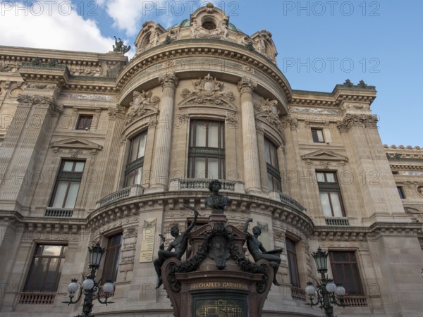 Fascinating front view of a magnificent opera house with richly decorated façade elements and statues, paris, france