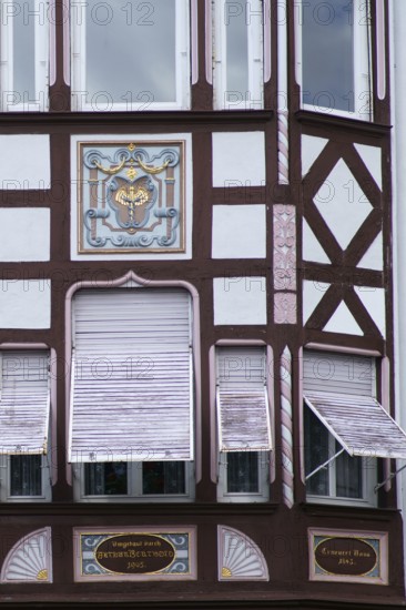 An old listed residential and commercial building of a former pharmacy with the coat of arms of the Hermes staff