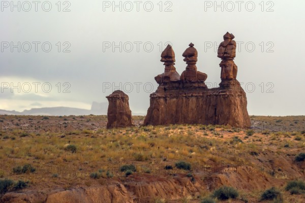 Hoodoo - geological formations. Original red brown sandstone formations resulting from erosion. Scenic Utah state park Goblin Valley. USA. The concept of active, ecological and photo tourism