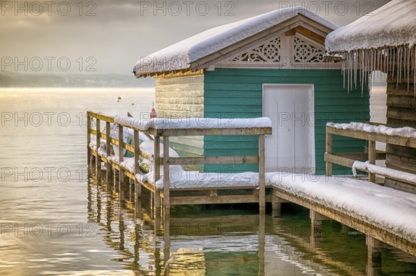 An image of the lake huts in Tutzing Bavaria Germany at winter sunrise