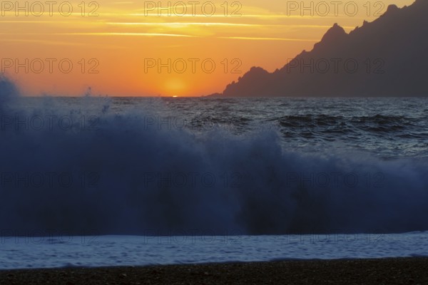 Surf wave at sunset on the beach in Porto, Corsica