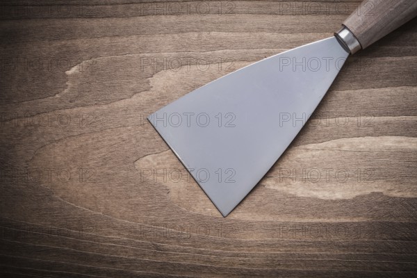 Putty spattle on wood board