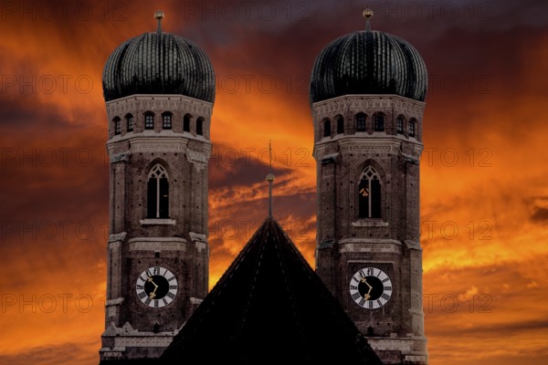 The silhouette of the two church towers of the Church of Our Lady in Munich against a dramatic twilight sky