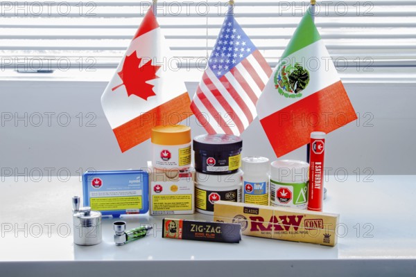 Calgary, Alberta, Canada. Sep 18, 2020. Canadian legal cannabis popular brands of marijuana weed plastic containers with USA, Mexico and Canada flag