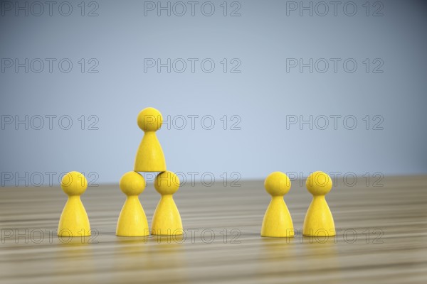 3d illustration of some game figures building a pyramid