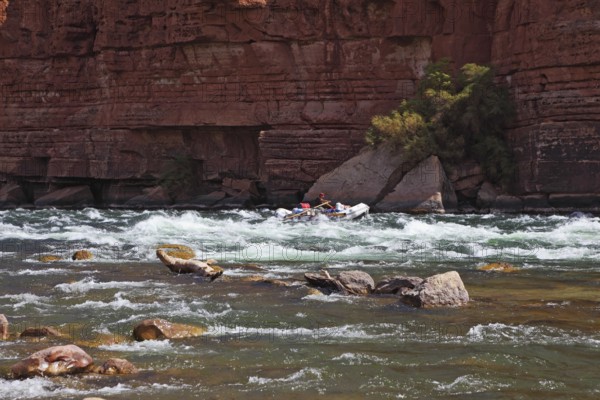 Sporting young woman in a kayak overcame stormy over the Colorado River